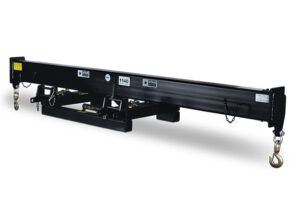 A black fork-mounted spreader bar on a white background. The spreader bar is a long, horizontal beam that attaches to the forks of a forklift to increase stability when lifting wide or unbalanced loads. It has two hooks on the underside for optional use with suspended loads.