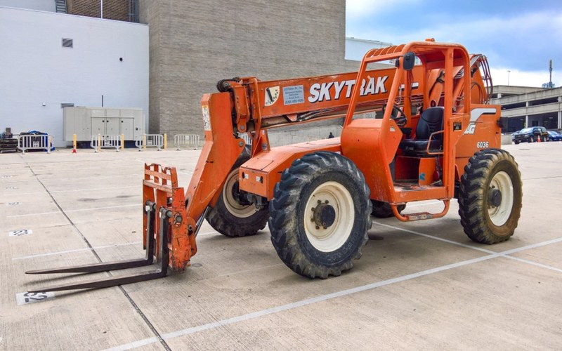 Telehandler forklift parked in equipment yard.