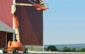 60ft Articulating Boom Lift extending over a roofline to provide safe elevated access for exterior construction and maintenance work.