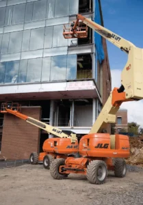 80ft Articulating Boom Lift providing elevated access for exterior construction and glazing installation on a commercial building project.