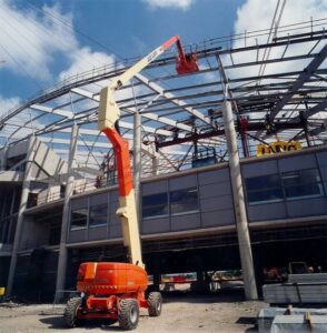 80ft Articulating Boom Lift reaching structural steel framing during commercial construction and high-access installation work.
