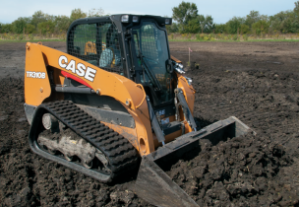 CASE compact track loader with bucket lowered on a dirt lot