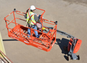 85ft Telescopic/Straight Boom Lift operated by a worker performing high-reach construction and inspection work from an elevated platform.