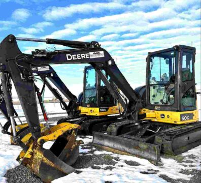 Two 5-tonne mini excavators on a job site, illustrating small excavator rental costs and equipment options for construction projects.
