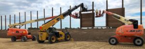 65ft Telescopic / Straight Boom Lift assisting with large-scale construction and structural installation work at an outdoor job site.